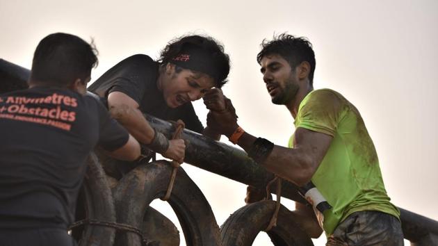 Participants helping each other during an obstacle race. (Arijit Sen/HT Photo)