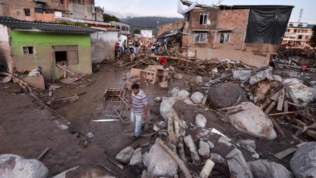 People walk through the rubble left by mudslides following heavy rains in Mocoa. Several deadly landslides have struck Colombia in recent months. (Luis Robayo/AFP)