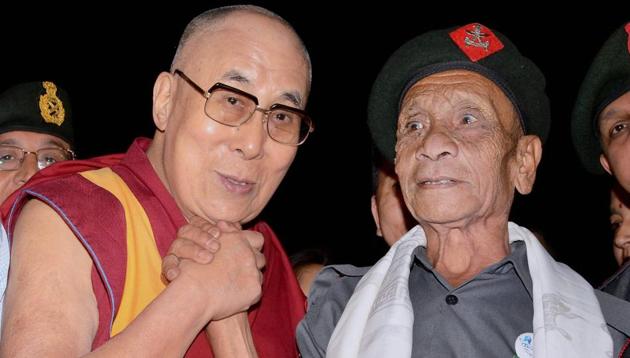 Tibetan spiritual leader the Dalai Lama with Naren Chandra Das, a retired havildar of the Assam Rifles, at the Namami Brahmaputra festival in Guwahati on Sunday.(PTI)