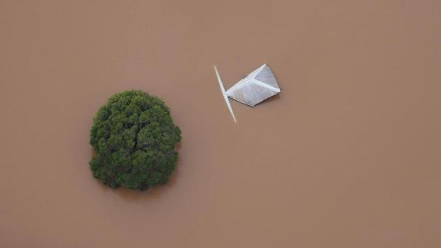 The top of a building and tree can be seen in floodwaters near the northern New South Wales town of Lismore, Australia on March 31, 2017 after Cyclone Debbie swelled rivers to record heights across the region. (AAP/Tracey Nearmy/REUTERS)