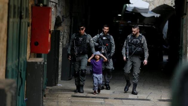 Israeli border policemen escort a boy away from a blocked alley after a stabbing attack inside the old city of Jerusalem according to Israeli police on April 1, 2017. The boy is not involved in the incident. (Ammar Awad/REUTERS)