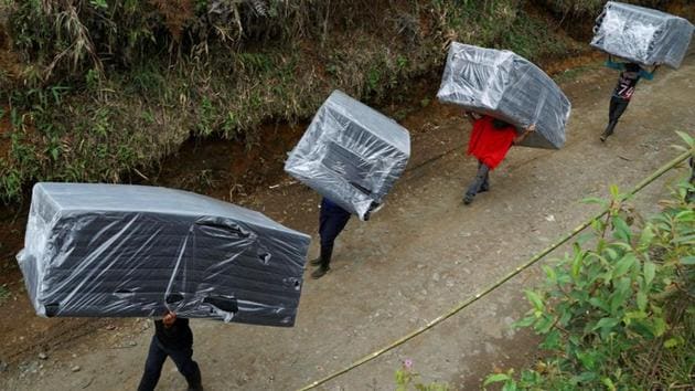 FARC members carry mattresses to their tents in a camp near the transitional zone of Pueblo Nuevo. Members of the Jacobo Arenas rebel unit, which operated in mountains of Cauca province, were among 6,900 FARC fighters who left behind clandestine camps where they had lived for decades, crisscrossing the country on foot, by boat and by truck to get to 26 zones monitored by the United Nations. (Federico Rios/REUTERS) FARC members carry mattresses to their tents in a camp near the transitional zone of Pueblo Nuevo. Members of the Jacobo Arenas rebel unit, which operated in mountains of Cauca province, were among 6,900 FARC fighters who left behind clandestine camps where they had lived for decades, crisscrossing the country on foot, by boat and by truck to get to 26 zones monitored by the United Nations. (Federico Rios/REUTERS)