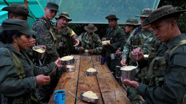 FARC members eat their last dinner before moving troops to Pueblo Nuevo. The government says it is working as quickly as possible to finish each camp, that the FARC is partly responsible for construction and that the facilities are far superior to the tarp and bamboo lean-tos traditionally used by the rebels. (Federico Rios/REUTERS) FARC members eat their last dinner before moving troops to Pueblo Nuevo. The government says it is working as quickly as possible to finish each camp, that the FARC is partly responsible for construction and that the facilities are far superior to the tarp and bamboo lean-tos traditionally used by the rebels. (Federico Rios/REUTERS)