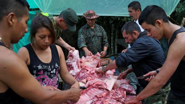 FARC members prepare meat to be cooked for dinner in Los Robles, Colombia. (Federico Rios/REUTERS) FARC members prepare meat to be cooked for dinner in Los Robles, Colombia. (Federico Rios/REUTERS)
