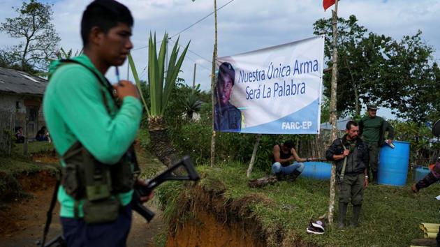 FARC members guard an entrance of a camp near the transitional zone of Pueblo Nuevo in the Cauca mountains. A first version was narrowly rejected in a referendum last year, before being modified and passed by Congress. (Federico Rios/REUTERS) FARC members guard an entrance of a camp near the transitional zone of Pueblo Nuevo in the Cauca mountains. A first version was narrowly rejected in a referendum last year, before being modified and passed by Congress. (Federico Rios/REUTERS)