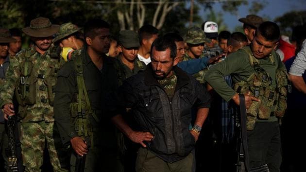 FARC members stand in a camp near the transitional zone of Pueblo Nuevo. The rebels are expected to turn in all arms by June, and some 8,000 are set to be registered by this weekend. (Federico Rios/REUTERS) FARC members stand in a camp near the transitional zone of Pueblo Nuevo. The rebels are expected to turn in all arms by June, and some 8,000 are set to be registered by this weekend. (Federico Rios/REUTERS)