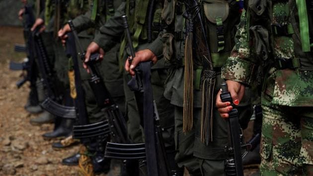 FARC members stand during a formation in a camp before moving to the transitional zone of Pueblo Nuevo. The Revolutionary Armed Forces of Colombia (FARC) signed a peace agreement with the government late last year to put an end to their part in Latin America’s longest-running armed conflict, which has killed more than 220,000 people and displaced millions. (Federico Rios/REUTERS) FARC members stand during a formation in a camp before moving to the transitional zone of Pueblo Nuevo. The Revolutionary Armed Forces of Colombia (FARC) signed a peace agreement with the government late last year to put an end to their part in Latin America’s longest-running armed conflict, which has killed more than 220,000 people and displaced millions. (Federico Rios/REUTERS)