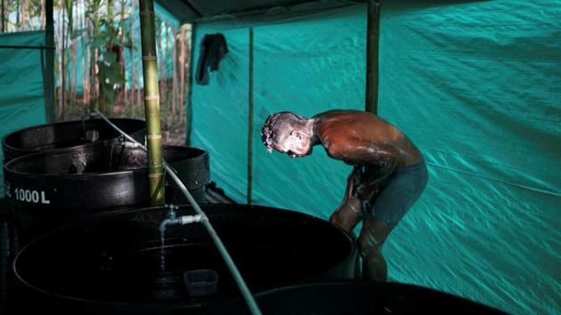 FARC member washes in a camp. The zones will be their homes for the foreseeable future as they complete judicial processes to determine whether they will serve special sentences for war crimes or receive amnesty. The FARC’s leadership has raised concerns about conditions in some of the camps, including the lack of permanent toilets and facilities such as gyms they say were agreed in the accord. (Federico Rios/REUTERS) FARC member washes in a camp. The zones will be their homes for the foreseeable future as they complete judicial processes to determine whether they will serve special sentences for war crimes or receive amnesty. The FARC’s leadership has raised concerns about conditions in some of the camps, including the lack of permanent toilets and facilities such as gyms they say were agreed in the accord. (Federico Rios/REUTERS)