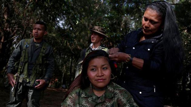 Karina gets her hair done by a friend in a camp while waiting for a truck to move to the transition zone of Pueblo Nuevo, at the Los Robles FARC camp, Colombia. Former fighters from Colombia’s FARC rebel group are handing over thousands of weapons and other materials to international officials in special camps, as the group’s six-month disarmament process continues. (Federico Rios/REUTERS) Karina gets her hair done by a friend in a camp while waiting for a truck to move to the transition zone of Pueblo Nuevo, at the Los Robles FARC camp, Colombia. Former fighters from Colombia’s FARC rebel group are handing over thousands of weapons and other materials to international officials in special camps, as the group’s six-month disarmament process continues. (Federico Rios/REUTERS)