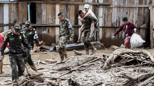 Handout picture released by the Colombian Army press office showing soldiers helping to evacuate locals following mudslides caused by heavy rains, in Mocoa, Putumayo department. Mudslides killed more than 200 people after heavy rains caused rivers to overflow in Colombia’s Putumayo province, authorities said. (AFP)