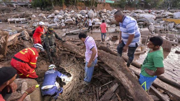 Rescuers seek people among the rubble left by mudslides following heavy rains in Mocoa. Rescuers clawed through piles of mud and twisted debris Sunday searching for survivors after violent mudslides destroyed homes in southern Colombia, killing over 200 people and injuring hundreds more. (Luis Robayo/AFP)