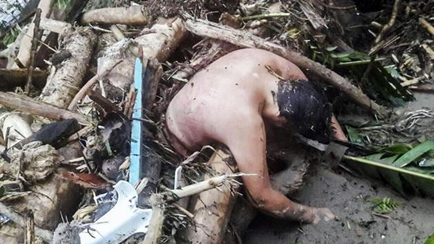Hand-out picture released by the Colombian Army press office showing the corpse of a man caught in a mudslide caused by heavy rains, in Mocoa. (AFP)