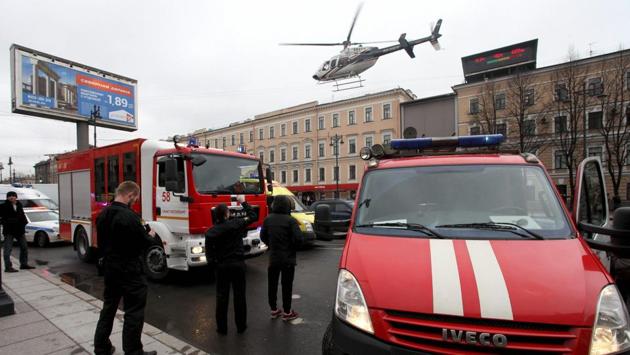 A helicopter flies over fire trucks after the explosion. Interfax quoted a source as saying that a suicide bomber was not responsible for the blast and it was most likely that an IED was planted in the train carriage. (AP/PTI) A helicopter flies over fire trucks after the explosion. Interfax quoted a source as saying that a suicide bomber was not responsible for the blast and it was most likely that an IED was planted in the train carriage. (AP/PTI)