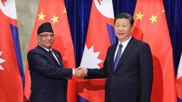 Chinese President Xi Jinping (R) shakes hands with Nepalese Prime Minister Pushpa Kamal Dahal (L) at the Great Hall of the People in Beijing on March 27(AFP)