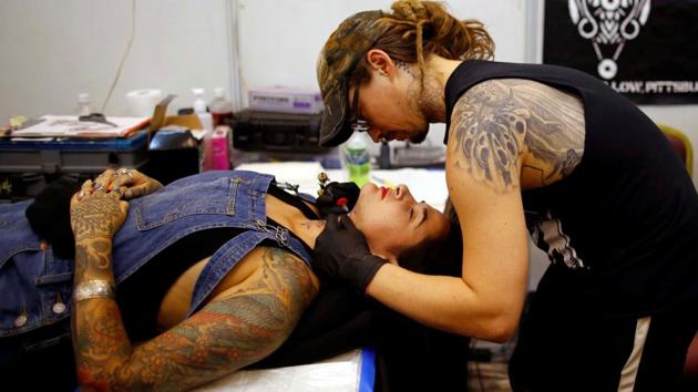 A tattoo artist making traditional tattoo during the 7th International Nepal Tattoo Convention. (Navesh Chitrakar / Reuters)