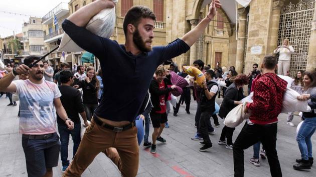 Cypriots participate in the annual pillow fight in Faneromeni Square in the old city of the capital Nicosia, on International Pillow Fight Day. (Iakovos Hatzistavrou / AFP)