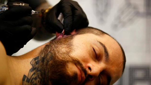 A man gets a tattoo on his ear .Nepal Tattoo Convention is the biggest Tattoo Convention in South Asia (Navesh Chitrakar / Reuters)