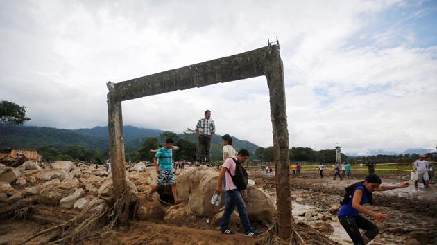 People walk in a destroyed area after flooding and mudslides caused by heavy rains in Mocoa, Colombia, on April 2.(Reuters Photo)
