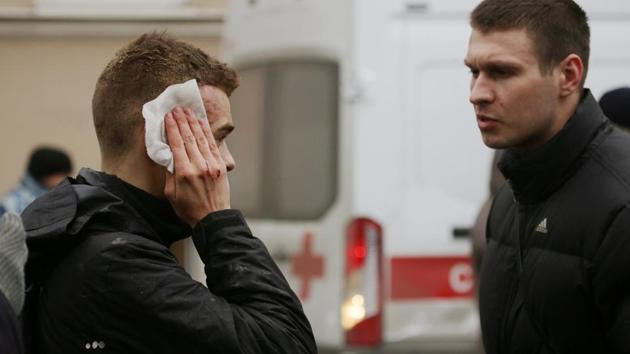 An injured person stands outside Sennaya Ploshchad metro station. Videos shared on social media showed confused commuters standing on smoke-filled subway platforms. (Anton Vaganov/REUTERS) An injured person stands outside Sennaya Ploshchad metro station. Videos shared on social media showed confused commuters standing on smoke-filled subway platforms. (Anton Vaganov/REUTERS)