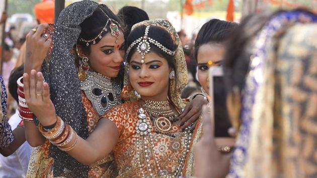 Students in traditional outfit make the best of the moment as they pose for a friend’s camera. (Raj K Raj/HT PHOTO)