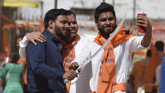 Enthusiastic youth take a picture with a sword during the event. 105 tableaux participated showcasing various initiatives like (Raj K Raj/HT PHOTO)