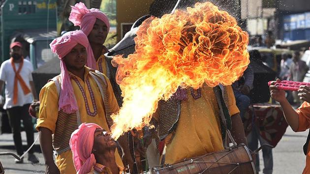 A fire-eater from Punjab performs to the heady beat of the traditional dhol. Participants from various states danced, sang and performed as they walked the 5km long rally. (Raj K Raj/HT PHOTO)