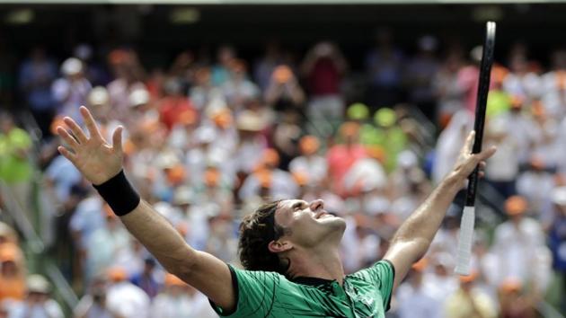 Roger Federer celebrates after defeating Rafael Nadal in the men's singles final at the Miami Open on Sunday.(AP Photo)