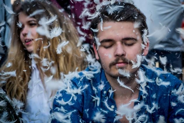 People take part in the International Pillow Fight. (ANDREI PUNGOVSCHI / AFP)