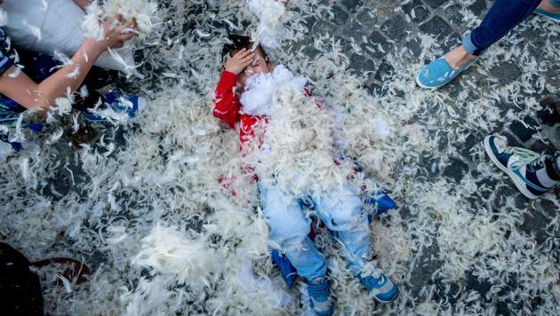 Children, teens, adults and seniors swung pillows at one another for over an hours. (ANDREI PUNGOVSCHI / AFP)