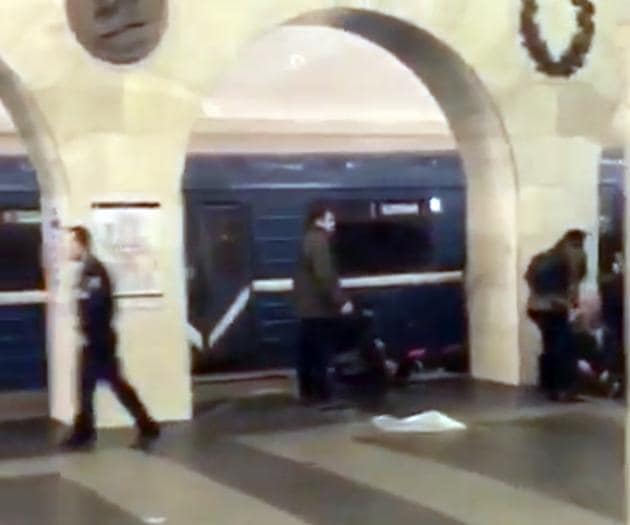 In this grab taken from AP video, Russian police officer, left, and people walk past the damaged train at the Tekhnologichesky Institut subway station in St.Petersburg, Russia, Monday, April 3, 2017. The subway in the Russian city of St. Petersburg is reporting that several people have been injured in an explosion on a subway train. (AP video via AP)(AP) In this grab taken from AP video, Russian police officer, left, and people walk past the damaged train at the Tekhnologichesky Institut subway station in St.Petersburg, Russia, Monday, April 3, 2017. The subway in the Russian city of St. Petersburg is reporting that several people have been injured in an explosion on a subway train. (AP video via AP)(AP)