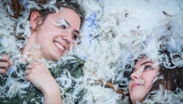 People take part in the International Pillow Fight event in Bucharest, Romania. (ANDREI PUNGOVSCHI / AFP)