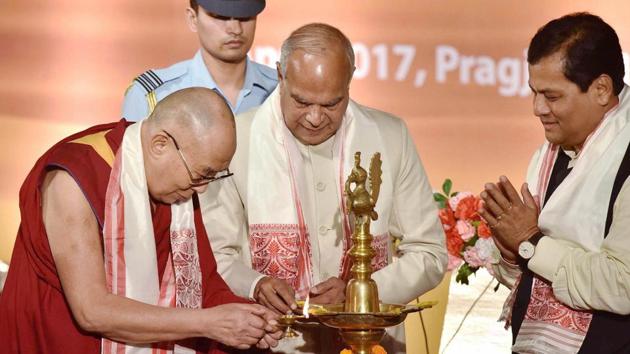 Tibetan spiritual leader Dalai Lama with Assam Governor Banwarilal Purohit and state Chief Minister Sarbananda Sonowal, lighting the lamp during a function in Guwahati . The Dalai Lama on April 1 started his tour of Assam and Arunachal Pradesh – which China claims is part of south Tibet. (PTI)