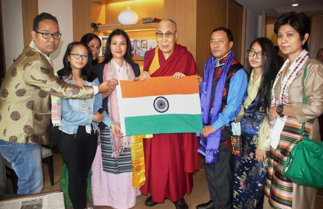 Tibetian Spiritual leader, the Dalai Lama presenting Indian National Flag to Ace mountaineer from Arunachal Pradesh Anshu Jamsenpa during the flag off ceremony of her Double Ascent Mt Everest Expedition 2017 in Guwahati. (PTI)
