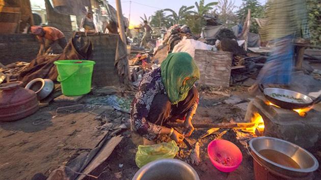 A Rohingya Muslim woman cooks in a semi-dismantled house in New Delhi.(HT File Photo)