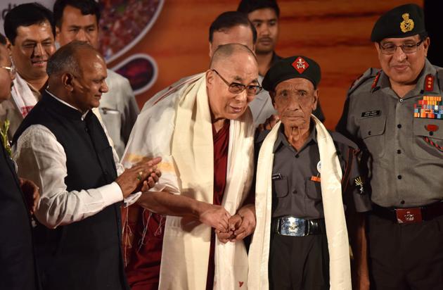 Tibetan spiritual leader the Dalai Lama (L) shakes hands with retired Assam Rifles personnel Naren Chandra Das. The Dalai Lama has had an emotional reunion with the Indian border guard who escorted him as he fled his native Tibet following a failed uprising nearly 60 years ago. The 81-year-old Tibetan spiritual leader, who has lived in exile ever since, was visibly emotional as he embraced the retired paramilitary guard on April 2 at the start of a visit to northeast India that has angered China. (Biju BORO / AFP)