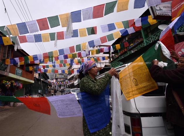 Buddhist followers hang prayer flags ahead of a visit by exiled Tibetan spiritual leader the Dalai Lama in Bomdila, in India's north-eastern state of Arunachal Pradesh. (Biju BORO / AFP)
