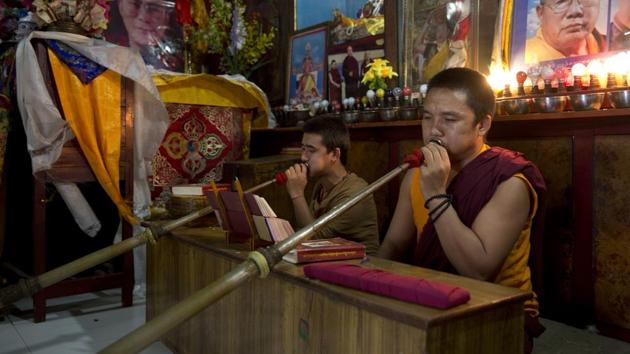 Exile Tibetan monks perform rituals inside a temple. (Tsering Topgyal / AP)