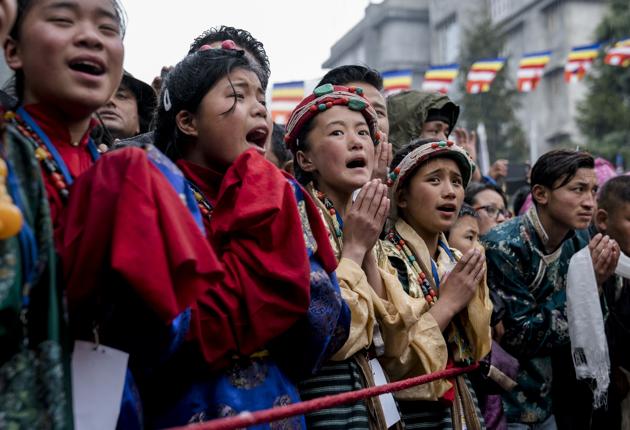 Devotees greet the Dalai Lama as he arrives at the Thubchok Gatsel Ling Monastery in Bomdila in Arunachal Pradesh. (Tenzin Choejor / AP)
