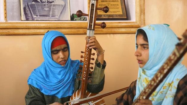 Kashmiri Muslim girls play instruments and sing Sufi music under the tutelage of music teacher, Muhammad Yaqoob Sheikh, on the outskirts of Srinagar. (PARVAIZ BUKHARI / AFP)