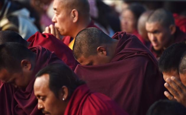Buddhist monks offer prayers as exiled Tibetan spiritual leader the Dalai Lama delivers religious teachings at the Buddha Stadium in Bomdila . (Biju BORO / AFP)