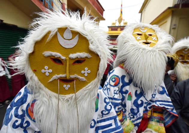 Arunachali mask dancers wear their traditional masks as they wait for exiled Tibetan spiritual leader the Dalai Lama arrival at the Thubchog Gatsel Ling Monastery in Bomdila.Tibetan spiritual leader, the Dalai Lama, on Tuesday began a week-long visit to Arunachal Pradesh, India’s easternmost state that is at the heart of a decades-old dispute with China. (Biju BORO / AFP)