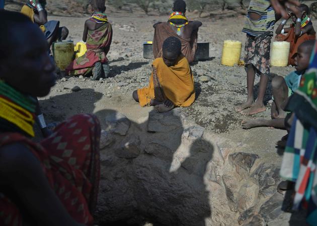 A young boy waits by the mouth of a rapidly drying waterhole near Lokitaung in northern Kenya’s Turkana county where a biting drought has ravaged livestock population . (TONY KARUMBA / AFP) A young boy waits by the mouth of a rapidly drying waterhole near Lokitaung in northern Kenya’s Turkana county where a biting drought has ravaged livestock population . (TONY KARUMBA / AFP)