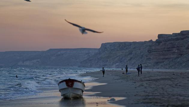In this photo taken Monday, March 6, 2017, fishermen stand on the Indian Ocean beach at dusk in the former pirate village of Eyl, in Somalia's semiautonomous northeastern state of Puntland.(AP Photo)