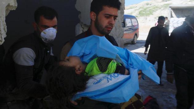 A man carries the body of a dead child, after what rescue workers described as a suspected gas attack in the town of Khan Sheikhoun in rebel-held Idlib, Syria . (Ammar Abdullah / REUTERS)