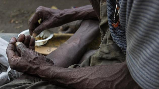The hands of a man eating alms by the roadside. With 25% of all hungry people of the world living in India, malnutrition plagues the country. An estimated 194.6 million people in India are undernourished with 44% of children underweight and 72% infants anaemic. (Vageesh Lall/ht photo) 