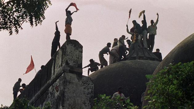 This file photo shows people shouting and waving banners as they stand on the top of a stone wall and celebrate the destruction of the 16th Century Babri Masjid in Ayodhya. (AFP File Photo) This file photo shows people shouting and waving banners as they stand on the top of a stone wall and celebrate the destruction of the 16th Century Babri Masjid in Ayodhya. (AFP File Photo)