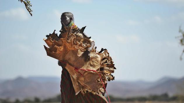 A Turkana woman carries dried skinned from goats she has lost to a biting drought that has ravaged livestock population in nothern Kenya near Lokitaung in Turkana county . (TONY KARUMBA / AFP) A Turkana woman carries dried skinned from goats she has lost to a biting drought that has ravaged livestock population in nothern Kenya near Lokitaung in Turkana county . (TONY KARUMBA / AFP)