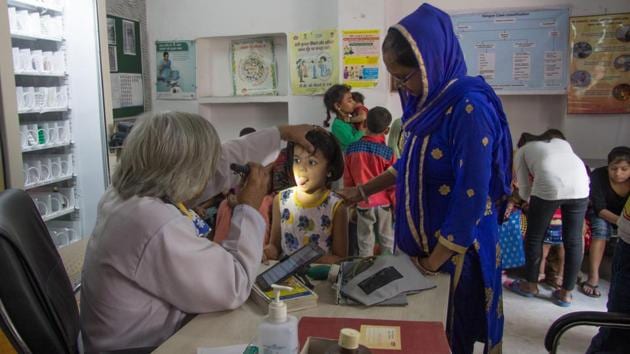 A young girl gets her tongue checked for cleanliness at a health center in Delhi. With the onset of summer comes a wave of infectious diseases like diarrhoea, cholera, typhoid and the likes which spread very fast in our densely populated country especially in the urban outskirts of major cities. (Vageesh Lall/ht photo) 