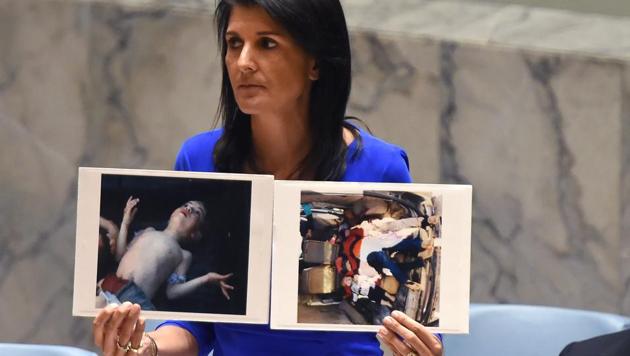 US Ambassador to the UN, Nikki Haley holds photos of victims as she speaks as the UN Security Council meets in an emergency session at the UN on April 5, 2017, about the suspected deadly chemical attack that killed civilians, including children, in Syria. (AFP) US Ambassador to the UN, Nikki Haley holds photos of victims as she speaks as the UN Security Council meets in an emergency session at the UN on April 5, 2017, about the suspected deadly chemical attack that killed civilians, including children, in Syria. (AFP)