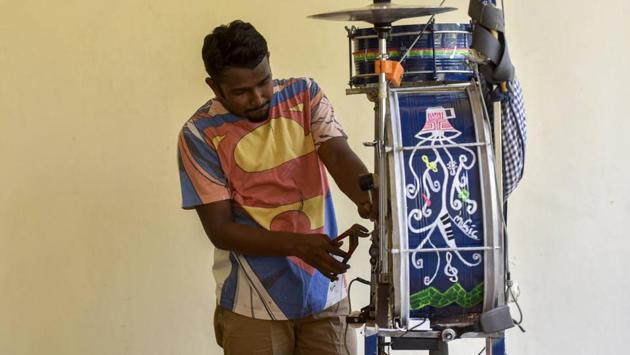 Peter Gladson hard at work at home fixing a drum set. (KUnal Patil/ht photo) 